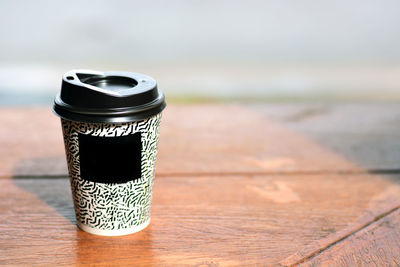 Close-up of disposable cup on table