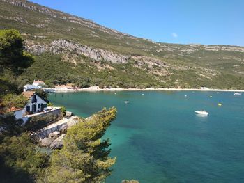 High angle view of sea and buildings against sky