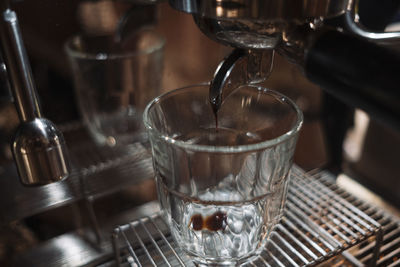 Close-up of coffee pouring in glass