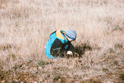 Cute boy playing on grassy field