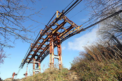 Low angle view of crane against sky