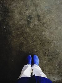 Low section of woman standing on tiled floor