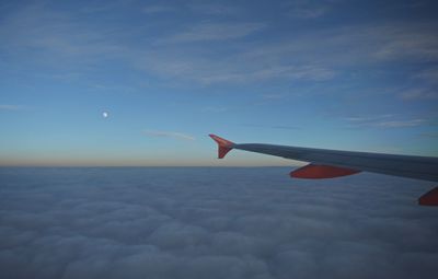 Airplane flying over cloudscape against sky