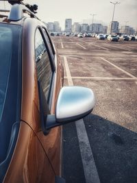 Close-up of side-view mirror of car on road