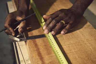 Cropped hands of carpenter working at workshop