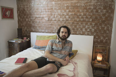 Young man lying on his bed