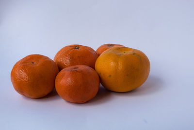 Close-up of oranges against white background
