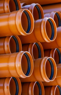 Stack of orange pvc pipes