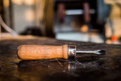 Close-up of hand tool on wooden table