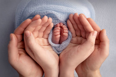 Close-up of baby holding hands