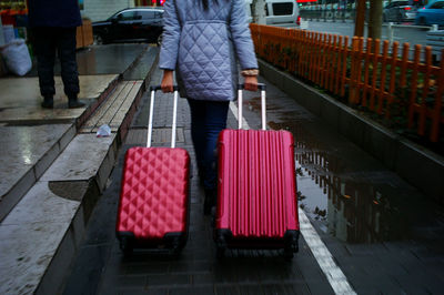 Rear view of women standing on zebra crossing
