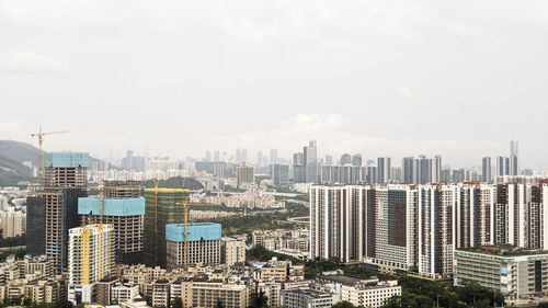 Aerial view of modern buildings in city against sky