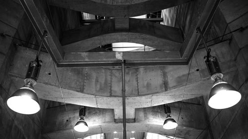 Low angle view of illuminated chandelier hanging from ceiling