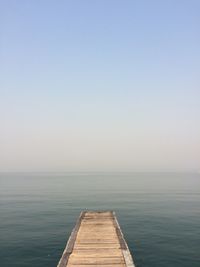 Pier over sea against clear sky