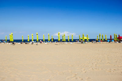 Scenic view of beach against clear blue sky