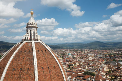 Dome of florence cathedral in city against cloudy sky