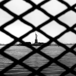 Close-up of chainlink fence against sky