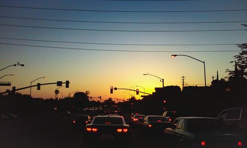 Cars on road at sunset