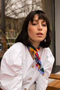 Portrait of a beautiful young woman standing outdoors