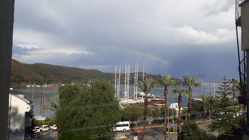Panoramic view of rainbow over city against sky