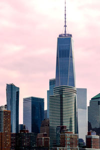 View of buildings in city against cloudy sky