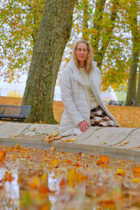 Full length of woman in park during autumn