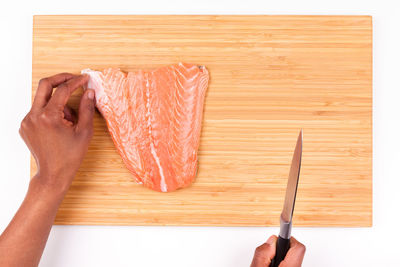 High angle view of person hand on cutting board
