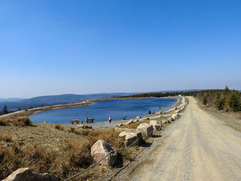 Panoramic shot of road against clear blue sky