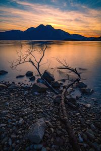 Scenic view of lake against sky during sunset