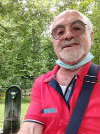 Portrait of man wearing mask against trees