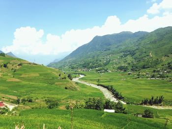 Scenic view of landscape against cloudy sky