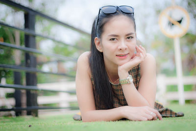 Portrait of a beautiful young woman sitting outdoors