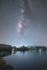 Scenic view of lake against sky at night