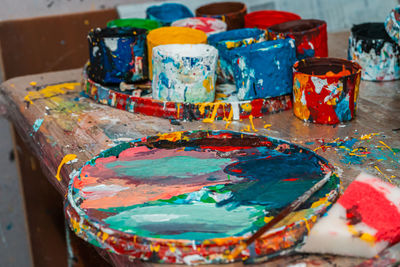 Close-up of multi colored paint on table