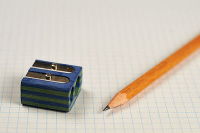 Close-up of pencil with sharpener on paper