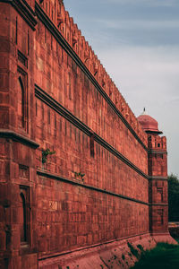 Low angle view of red building against sky