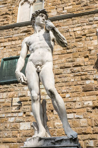 Low angle view of statue against building