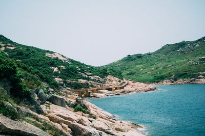Scenic view of cliff by sea