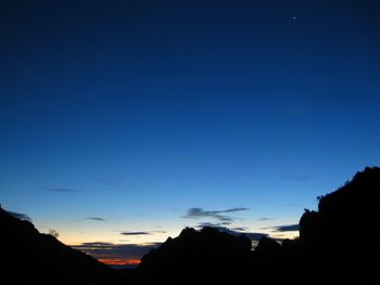 Scenic shot of silhouette mountains against sky at dusk