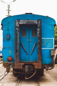 Train on railroad track against blue sky