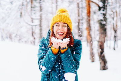 Portrait of woman standing on snow