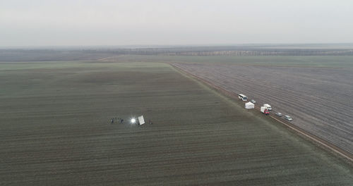 High angle view of vehicles on field against sky
