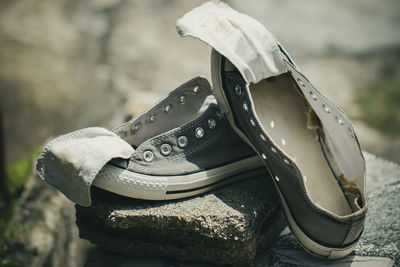 Close-up of shoes on rock