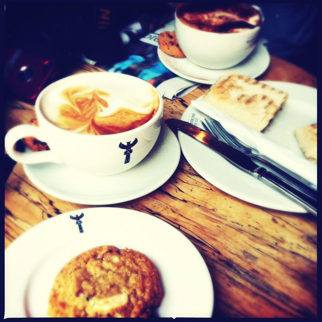 food and drink, indoors, freshness, table, drink, food, coffee cup, coffee - drink, refreshment, plate, ready-to-eat, saucer, still life, breakfast, spoon, coffee, indulgence, sweet food, high angle view, frothy drink