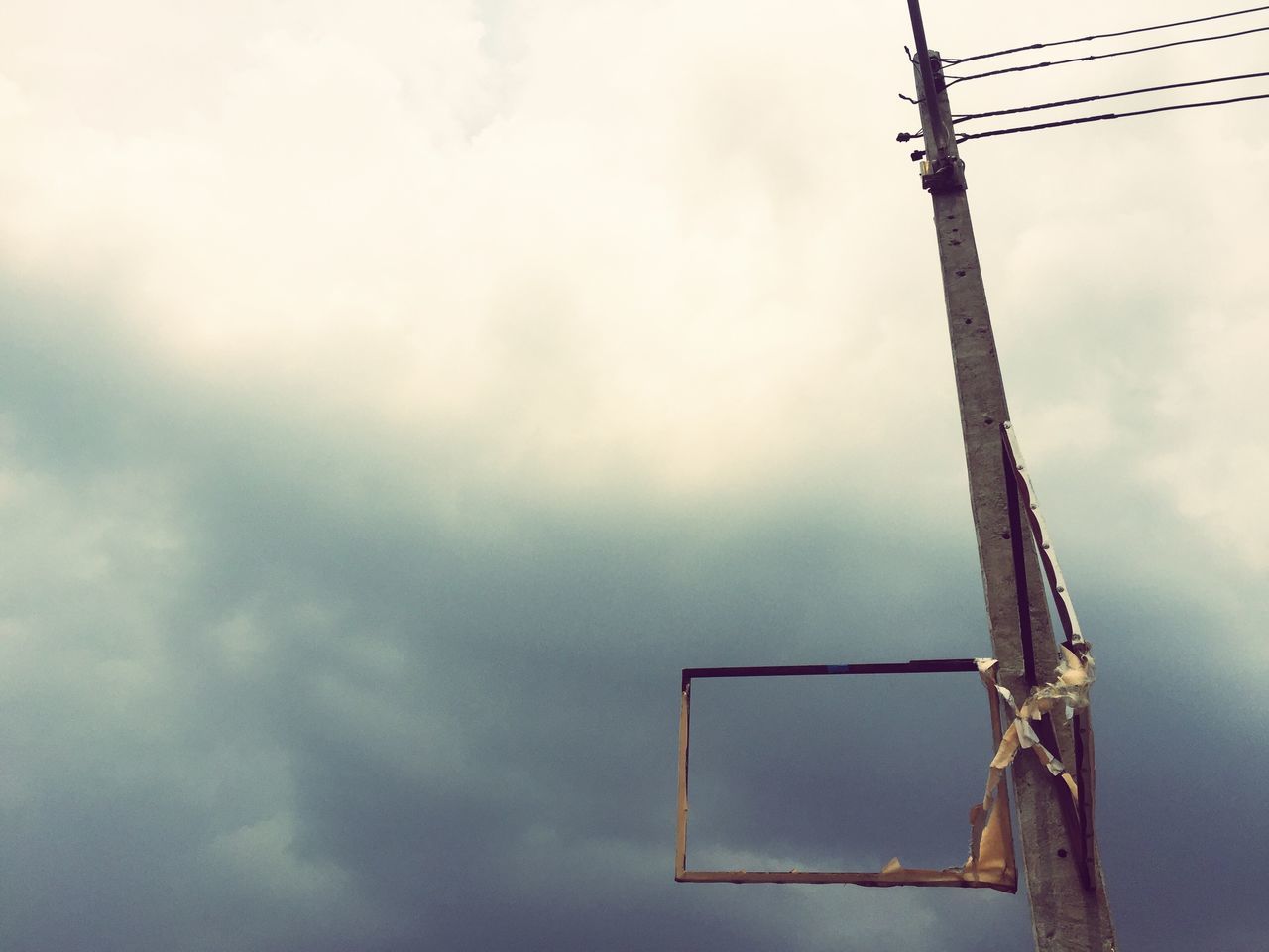 low angle view, sky, cloud - sky, cloudy, fuel and power generation, electricity, technology, weather, cloud, overcast, pole, power line, day, cable, outdoors, no people, nature, power supply, environmental conservation, electricity pylon