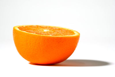 Close-up of orange slice against white background