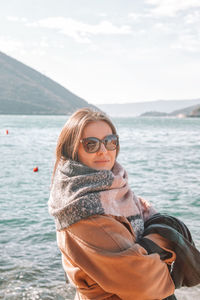 Portrait of smiling young woman in sea