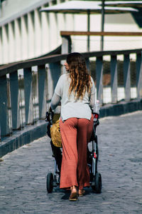 Rear view of woman with umbrella on bus