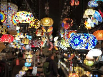 Illuminated lanterns hanging in store for sale in market