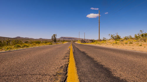 Surface level view of country road against sky